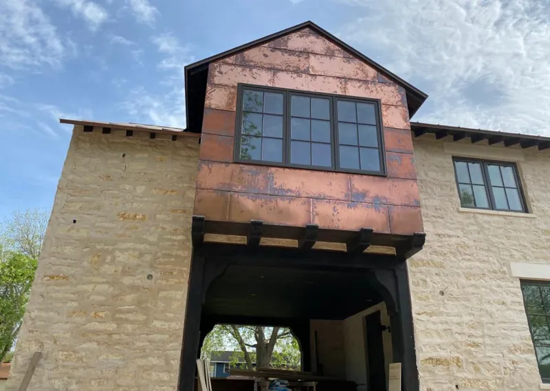 Copper metal panel facade on a stone building for Skylight Installation in Weddington